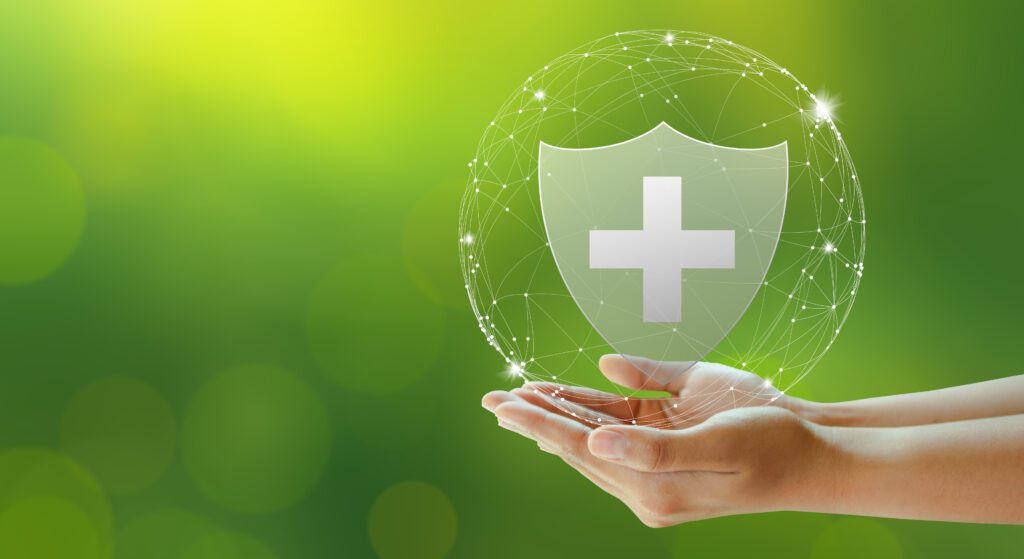 Family life insurance, Medical care insurance, and Business heal Hand offer medical shield on green background. Family life insurance, Medical care insurance, and Business healthy concepts.