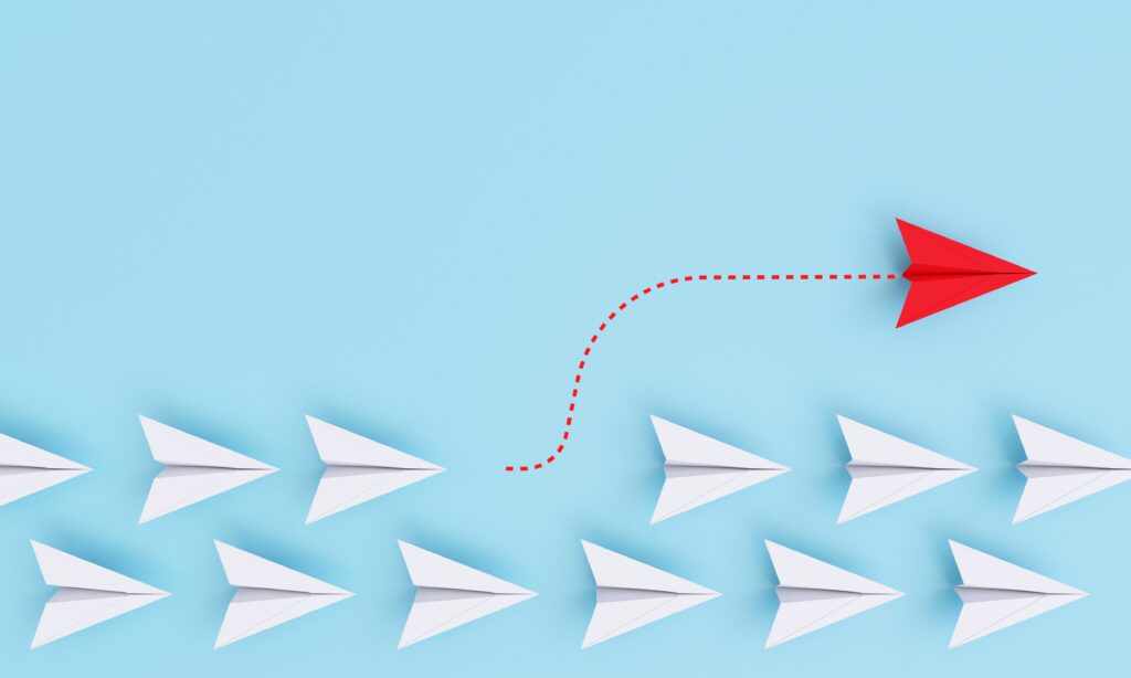 Red paper plane out of line with white paper to change disrupt a Red paper plane out of line with white paper to change disrupt and finding new normal way on blue background. Lift and business creativity new idea to discovery innovation technology by 3d rendering.